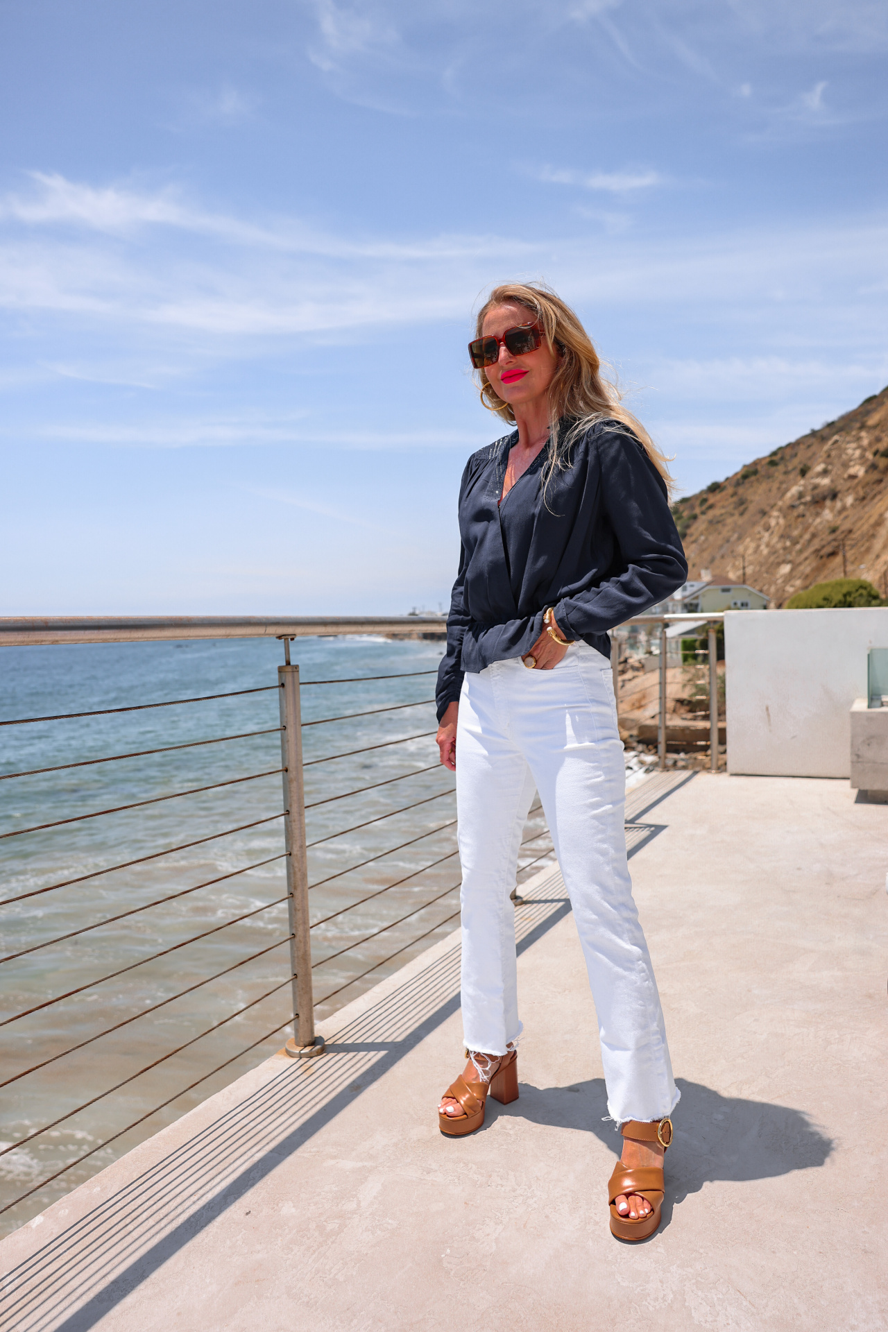 summer mom style, best summer mom outfits, summer mom outfits 2022, casual mom outfits summer, stylish mom outfits 2022, fashion for moms in their 30s, fashion for moms in their 40s, cute mom outfits, casual mom outfits, erin busbee, busbee style, fashion over 40, malibu, california, navy zadig & voltaire faux wrap front top, white mother hustler jeans, see by chloe platform heels, saint laurent square sunglasses, paco rabbane chunky gold necklace, dean davidson hoops