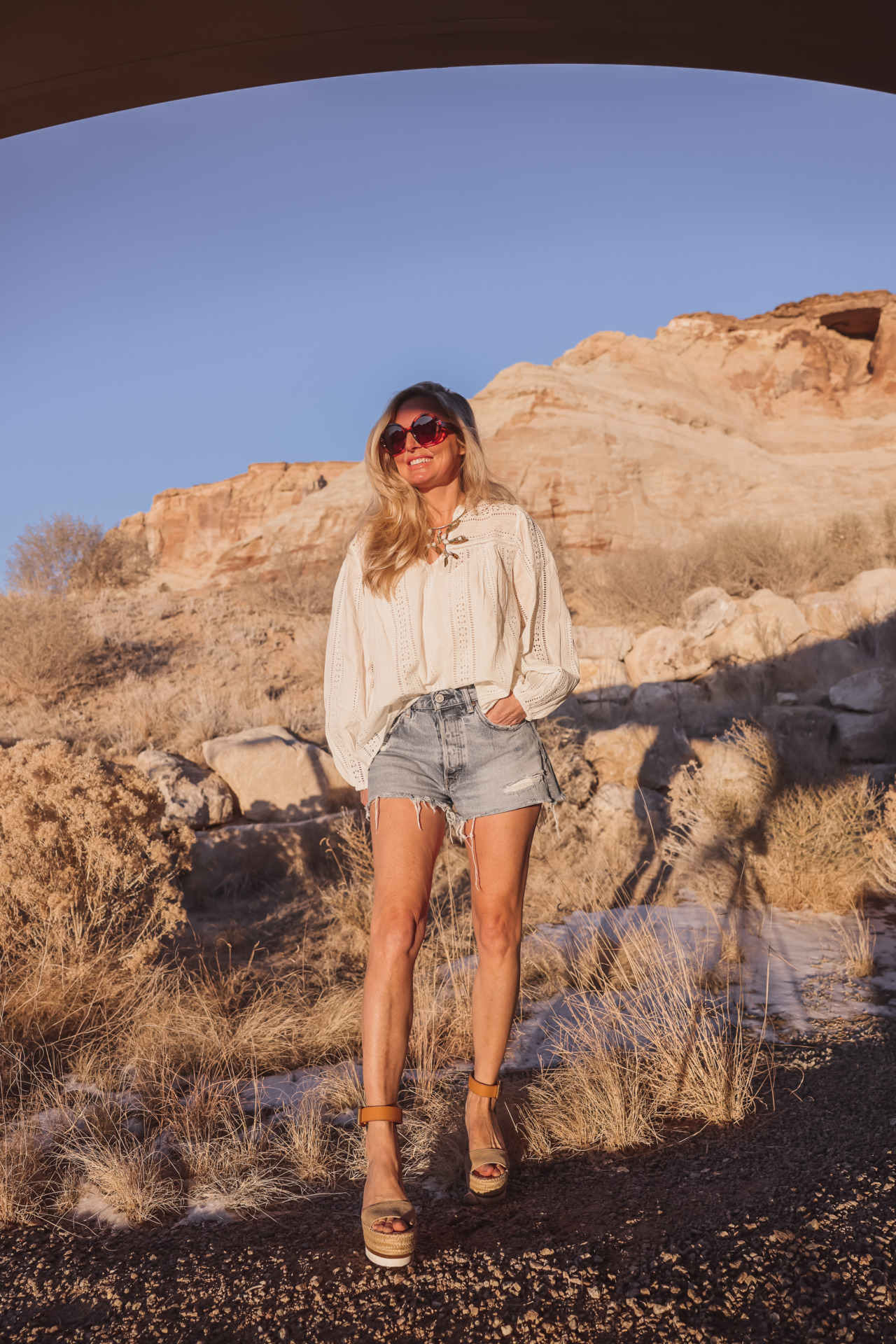 age appropriate denim shorts, denim shorts over 40, how to wear shorts over 40, erin busbee, busbee style, fashion over 40, moussy vintage packard shorts, see by chloe wedges, vlevert eyelet blouse, gucci sunglasses, amangiri resort utah