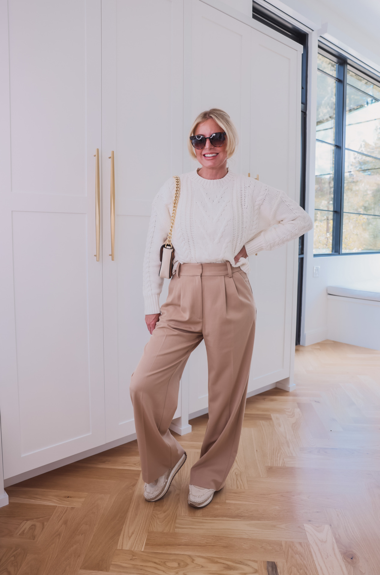 how to wear pleated pants, ways to wear pleated pants, ways to style pleated pants, how to style pleated pants, pleated trousers women, pleated pants over 40, favorite daughter pleated pants, pleated pants 2023, pleated pants outfits, erin busbee, busbee style, fashion over 40, pistola white cable knit sweater, rag & bone espadrille sneakers, le spec sunglasses, marc jacobs tri-color handbag, best items from shopbop sale, best shopbal sale items, shopbop sale, fall shopbop sale